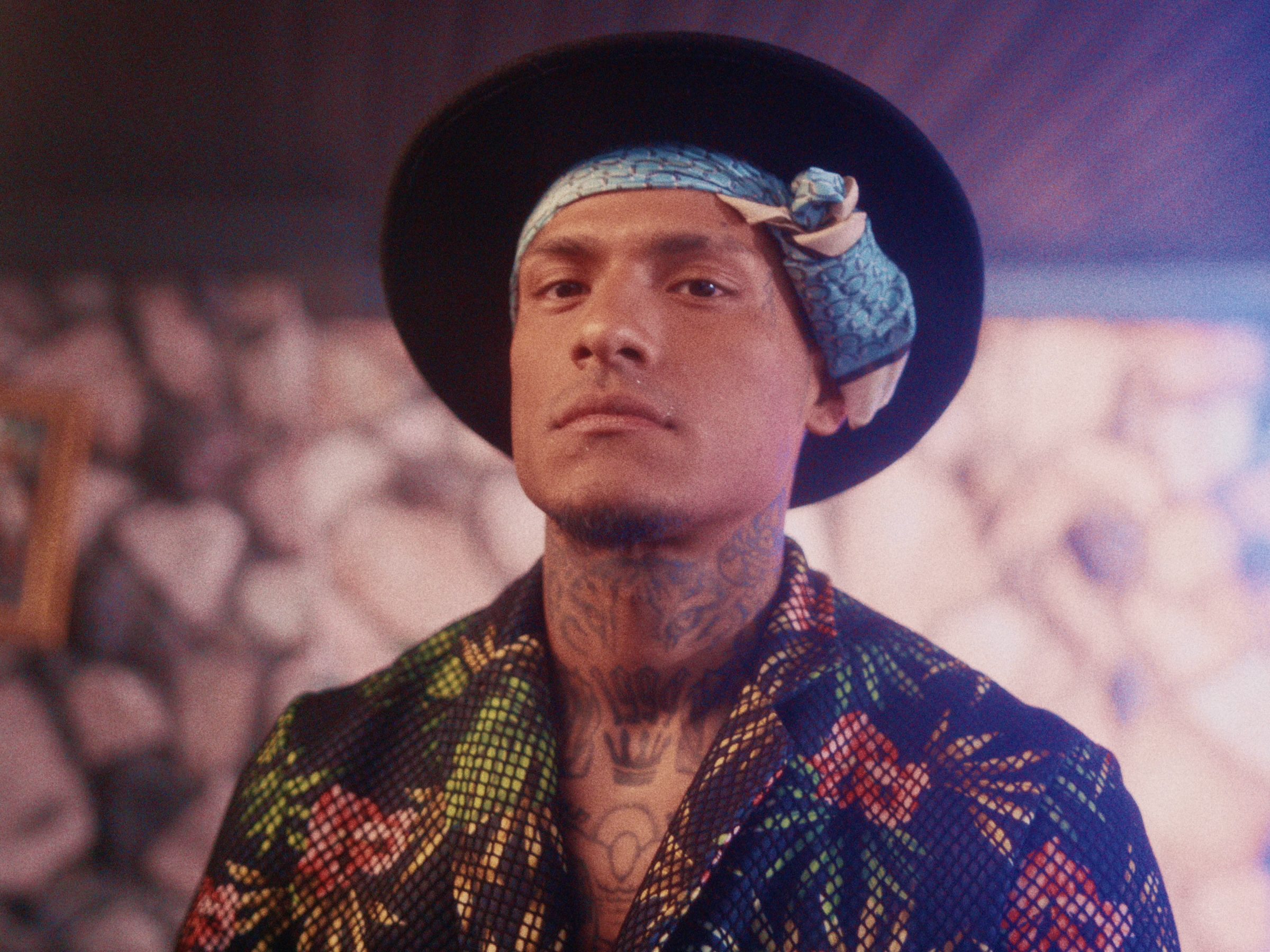 A man in a black hat and bandana in a stone-walled room, with the bleach skipped by the amount the slider shows